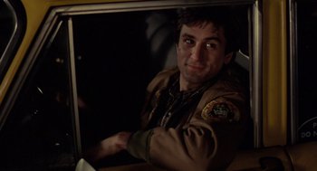 Movie still from “Taxi Driver” (1976), directed by Martin Scorsese – A man in a brown jacket is looking out a window; Close Up shot, Over the shoulder angle