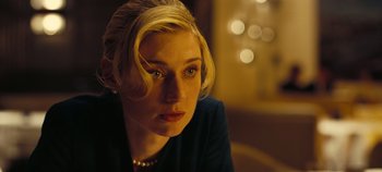 Movie still from “Tenet” (2020), directed by Christopher Nolan – A woman with blonde hair sitting in front of a mirror; Close Up shot, Low angle