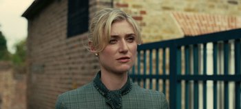 Movie still from “Tenet” (2020), directed by Christopher Nolan – A woman with blonde hair wearing a green jacket; Close Up shot, Low angle