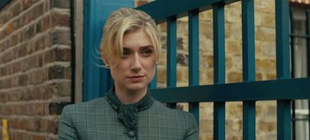 Movie still from “Tenet” (2020), directed by Christopher Nolan – A woman with blonde hair wearing a jacket; Close Up shot, Over the shoulder angle