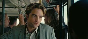 Movie still from “Tenet” (2020), directed by Christopher Nolan – A person riding a bus on a train; Close Up shot, Over the shoulder angle