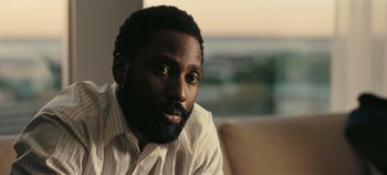 Movie still from “Tenet” (2020), directed by Christopher Nolan – A person with a beard; Close Up shot, High angle