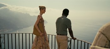 Movie still from “Tenet” (2020), directed by Christopher Nolan – A man and a woman looking out over the ocean; Medium shot, Over the shoulder angle