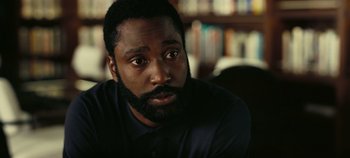 Movie still from “Tenet” (2020), directed by Christopher Nolan – A person with a beard; Close Up shot, Over the shoulder angle