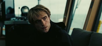 Movie still from “Tenet” (2020), directed by Christopher Nolan – A person wearing a black jacket; Close Up shot, Over the shoulder angle