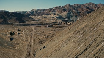 Movie still from “Tenet” (2020), directed by Christopher Nolan – An aerial view of an open pit mining area; Extreme Wide shot, High angle