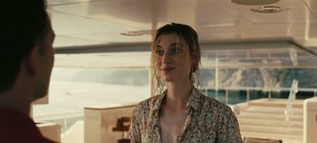 Movie still from “Tenet” (2020), directed by Christopher Nolan – A woman with wet hair standing in front of a window; Close Up shot, Low angle