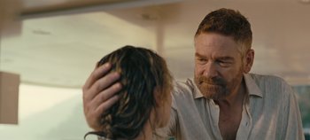 Movie still from “Tenet” (2020), directed by Christopher Nolan – A man is combing a woman's hair in a bathroom; Close Up shot, Over the shoulder angle
