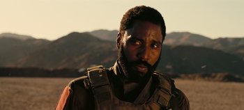 Movie still from “Tenet” (2020), directed by Christopher Nolan – A person with a beard; Close Up shot, Over the shoulder angle