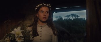 Movie still from “Tess” (1979), directed by Roman Polanski – A young woman wearing a flower crown in front of a window; Close Up shot, Over the shoulder angle