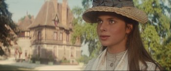 Movie still from “Tess” (1979), directed by Roman Polanski – A young woman wearing a straw hat in front of a house; Close Up shot, Low angle