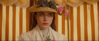 Movie still from “Tess” (1979), directed by Roman Polanski – A young woman wearing a straw hat with pink flowers on it; Close Up shot, Low angle