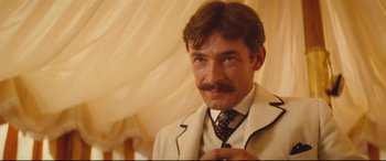 Movie still from “Tess” (1979), directed by Roman Polanski – A person wearing a suit and tie; Close Up shot, Over the shoulder angle