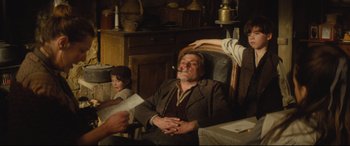 Movie still from “Tess” (1979), directed by Roman Polanski – An old man sitting in a chair smoking a cigarette; Medium shot, High angle