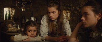 Movie still from “Tess” (1979), directed by Roman Polanski – A girl and a girl sitting on the ground; Medium shot, High angle