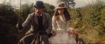 Movie still from “Tess” (1979), directed by Roman Polanski – A man and a woman sitting on a bench; Medium shot, High angle