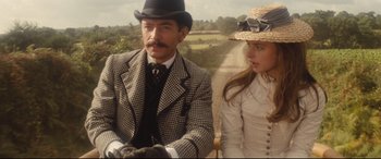 Movie still from “Tess” (1979), directed by Roman Polanski – A man and a woman wearing hats and gloves; Medium shot, Low angle