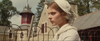 Movie still from “Tess” (1979), directed by Roman Polanski – A woman in a white dress and a white headscarf; Close Up shot, Low angle