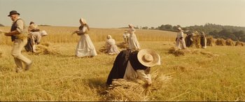 Movie still from “Tess” (1979), directed by Roman Polanski – A group of people in the middle of a wheat field; Extreme Wide shot, High angle