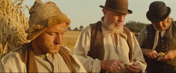 Movie still from “Tess” (1979), directed by Roman Polanski – Two men standing next to each other in a field; Medium shot, Low angle