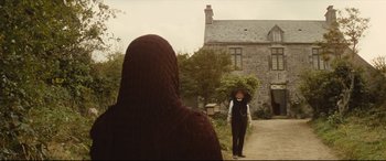 Movie still from “Tess” (1979), directed by Roman Polanski – An older woman walking down a path in front of an older man; Wide shot, Over the shoulder angle