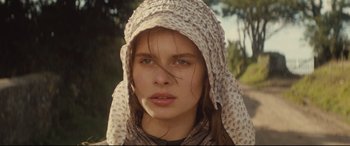 Movie still from “Tess” (1979), directed by Roman Polanski – A young woman wearing a scarf and a hat; Close Up shot, Low angle