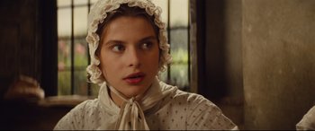 Movie still from “Tess” (1979), directed by Roman Polanski – A young woman wearing a white bonnet and a white dress; Close Up shot, Low angle