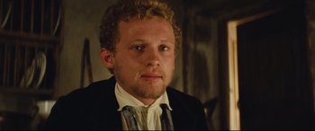 Movie still from “Tess” (1979), directed by Roman Polanski – A person wearing a suit and tie; Close Up shot, Over the shoulder angle