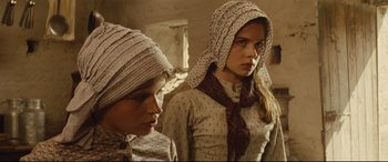 Movie still from “Tess” (1979), directed by Roman Polanski – Two young women in a room with a brick wall; Close Up shot, Low angle