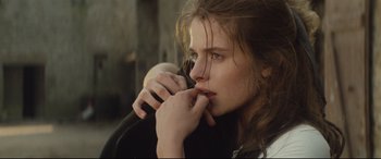 Movie still from “Tess” (1979), directed by Roman Polanski – A young woman holding a cell phone up to her ear; Close Up shot, Over the shoulder angle