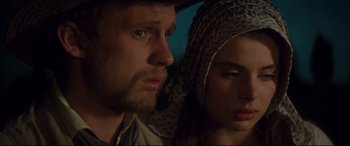 Movie still from “Tess” (1979), directed by Roman Polanski – A man and a woman looking at the camera; Close Up shot, Low angle