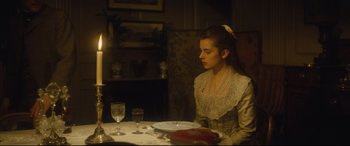 Movie still from “Tess” (1979), directed by Roman Polanski – A woman sitting at a table with a plate of food in front of her; Medium shot, High angle