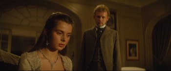 Movie still from “Tess” (1979), directed by Roman Polanski – A man and a woman standing next to each other in a room; Close Up shot, Over the shoulder angle