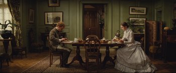 Movie still from “Tess” (1979), directed by Roman Polanski – A man and a woman sitting at a dining room table; Wide shot, High angle