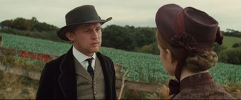 Movie still from “Tess” (1979), directed by Roman Polanski – A man and a woman wearing hats and a suit; Close Up shot, Over the shoulder angle