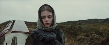 Movie still from “Tess” (1979), directed by Roman Polanski – A young woman with a scarf wrapped around her head; Close Up shot, Low angle
