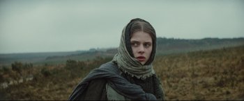 Movie still from “Tess” (1979), directed by Roman Polanski – A woman with a scarf on her head and face; Close Up shot, Low angle