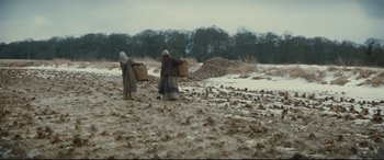 Movie still from “Tess” (1979), directed by Roman Polanski – Two women carrying baskets in a field of dirt; Wide shot, High angle
