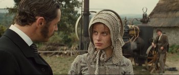Movie still from “Tess” (1979), directed by Roman Polanski – A woman in a hat and a man standing next to her; Close Up shot, Over the shoulder angle