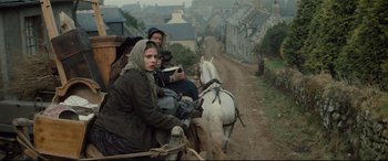 Movie still from “Tess” (1979), directed by Roman Polanski – A group of people riding in a carriage down a dirt road; Wide shot, High angle