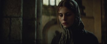 Movie still from “Tess” (1979), directed by Roman Polanski – A woman with a scarf on her head looking at the camera; Close Up shot, Over the shoulder angle