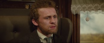 Movie still from “Tess” (1979), directed by Roman Polanski – A person wearing a suit and tie; Close Up shot, Over the shoulder angle