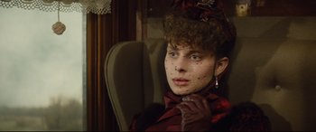 Movie still from “Tess” (1979), directed by Roman Polanski – A woman in a red dress and a red hat; Close Up shot, Low angle