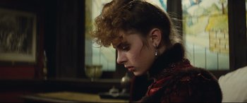 Movie still from “Tess” (1979), directed by Roman Polanski – A woman with a red dress and a red scarf; Close Up shot, Over the shoulder angle