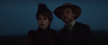 Movie still from “Tess” (1979), directed by Roman Polanski – A man and a woman standing next to each other; Close Up shot, Low angle