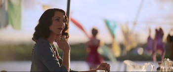 Movie still from “Elvis” (2022), directed by Baz Luhrmann – A woman sitting in front of a body of water; Medium shot, Over the shoulder angle