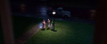 Movie still from “Elvis” (2022), directed by Baz Luhrmann – A group of women standing next to a street light; Extreme Wide shot, High angle