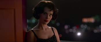 A beautiful young woman with short brown hair wearing a polka dot dress