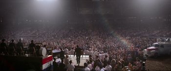 Movie still from “Elvis” (2022), directed by Baz Luhrmann – A large crowd of people in a large stadium; Extreme Wide shot, High angle