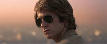 Movie still from “Elvis” (2022), directed by Baz Luhrmann – A person wearing sunglasses; Close Up shot, Low angle